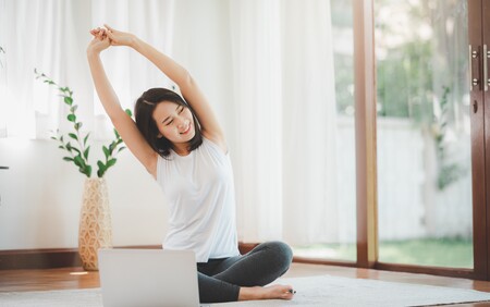 Woman Doing Stretching Warm up Exercise in Living Room at Her Home