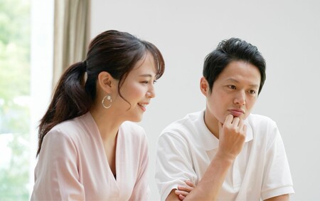 male and female looking at computer in home