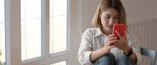 Woman reading fertility news on phone